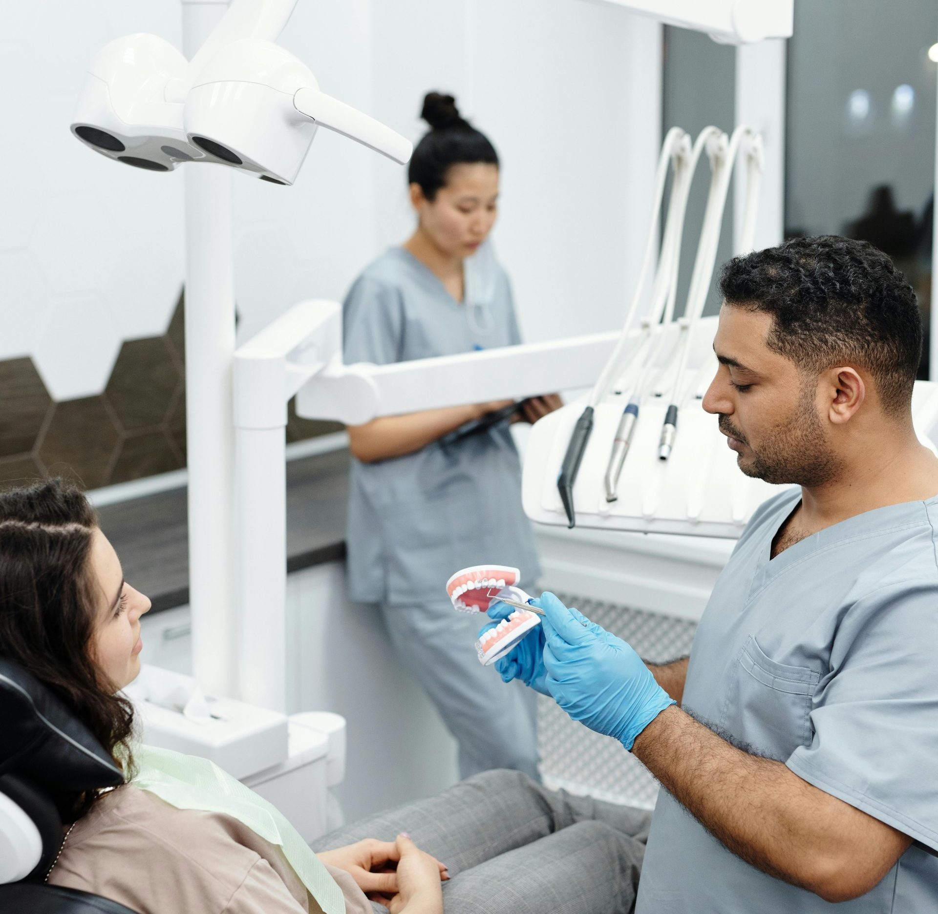 Dentist explains dental procedure to patient in a modern clinic setting.